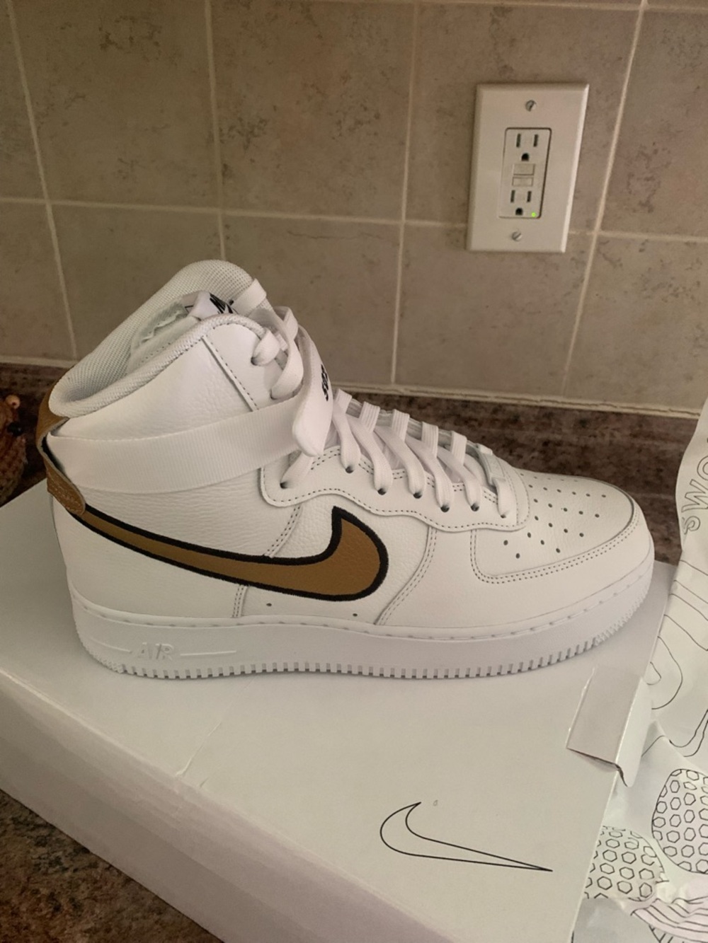 Nike White High-Top Sneakers with Gold Swoosh